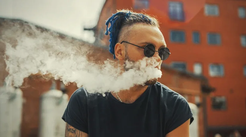 man inhaling pax